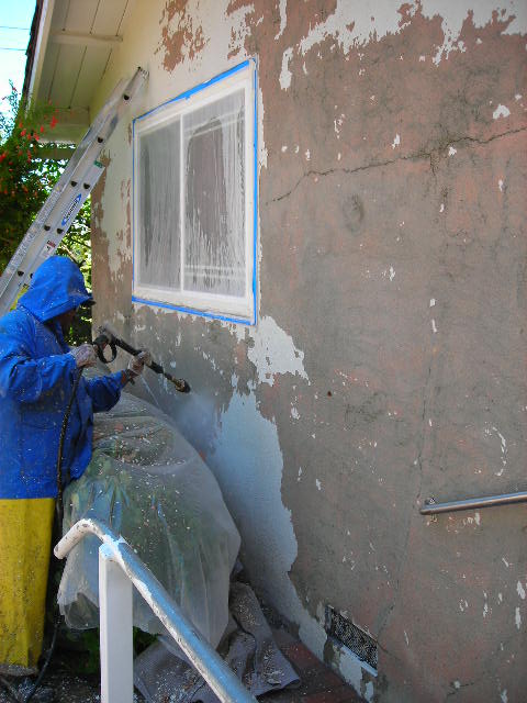 Man Removing Old Color with Pressure Gun